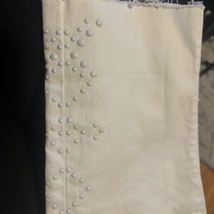 Woman’s cropped Levi with cute decorate bottoms .